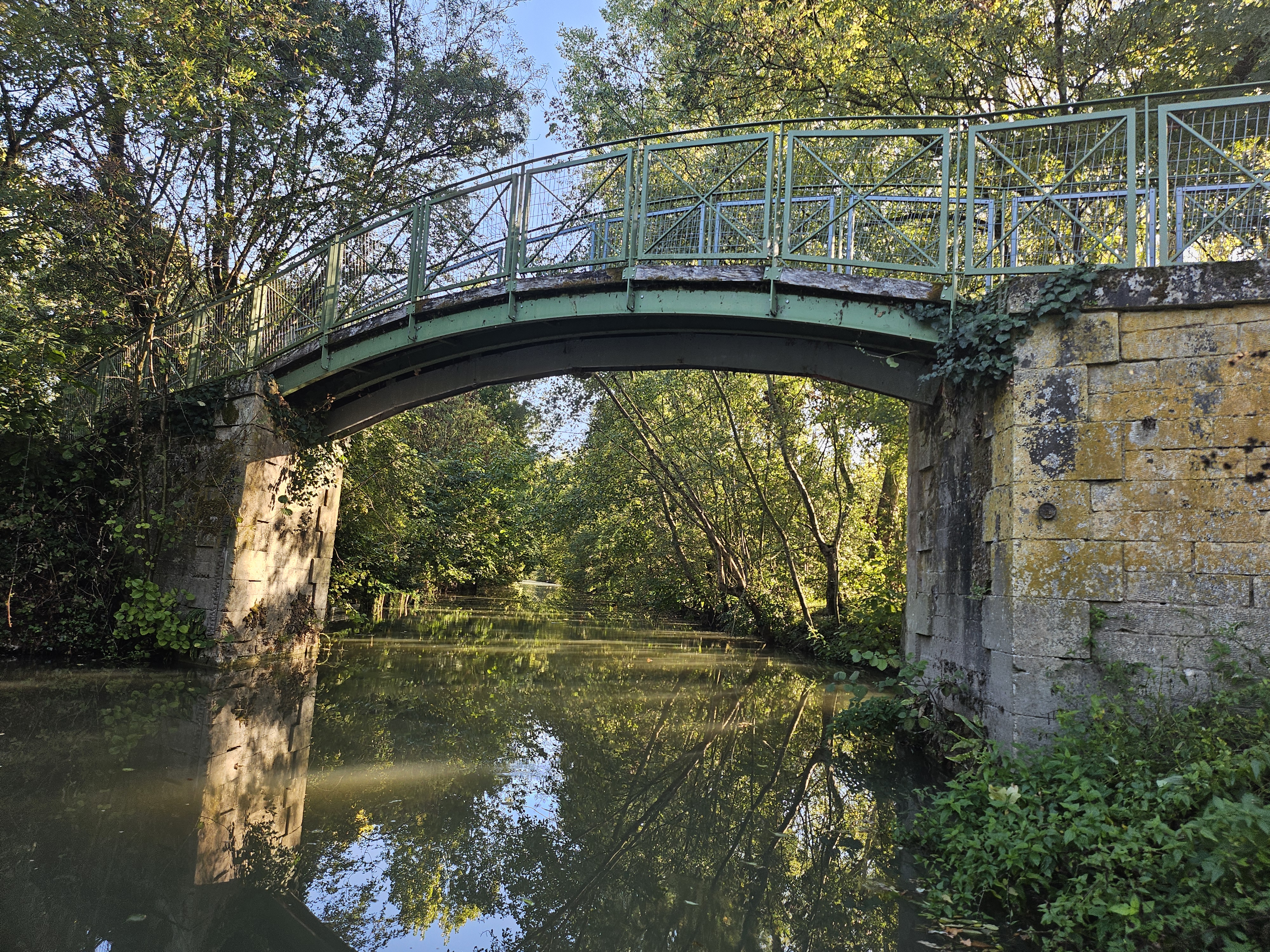 Traditional stone bridge spanning the village canal in Arçais