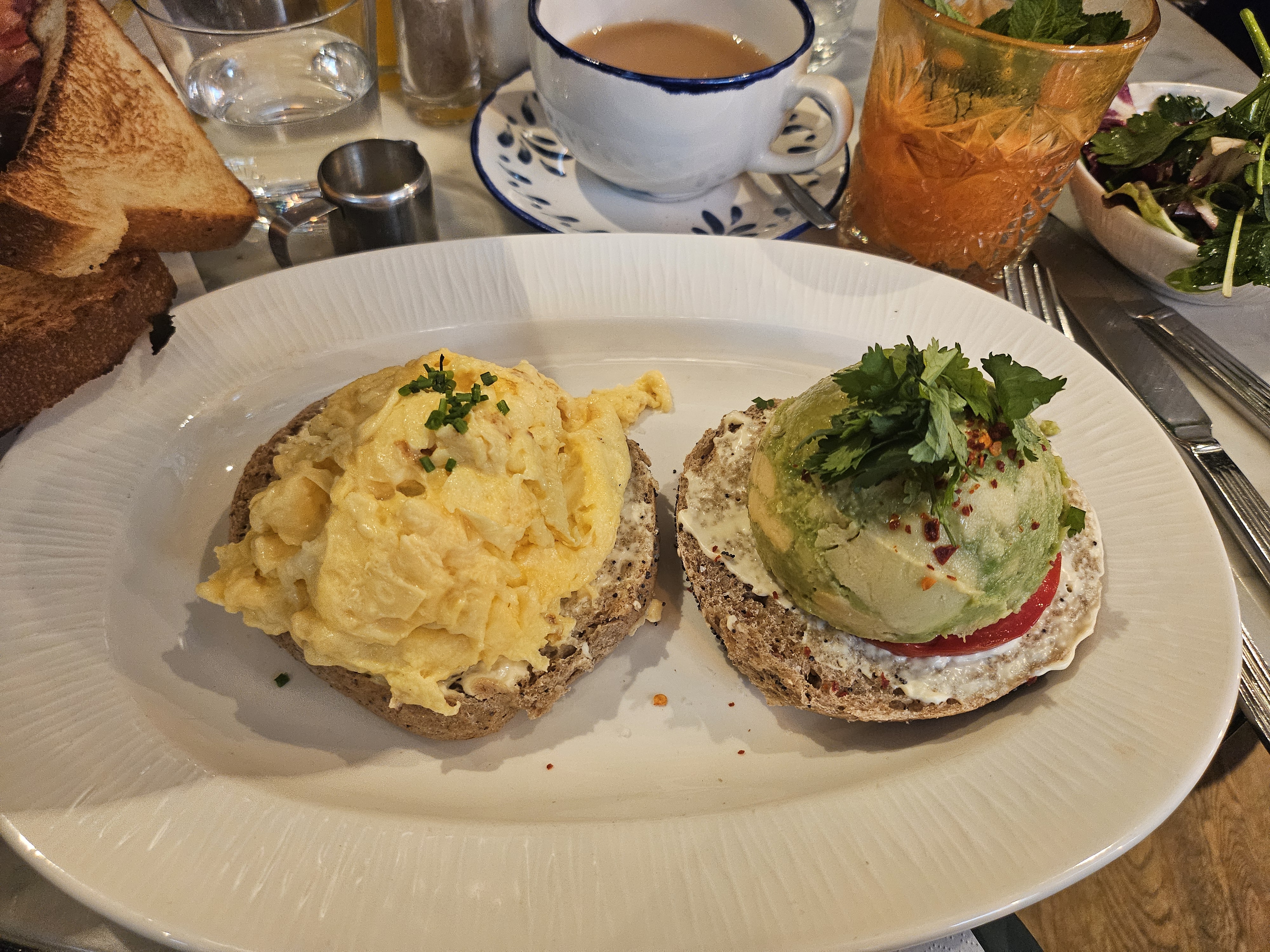 Recovery breakfast spread at Benedict Berlin with avocado bagel and fresh bread basket
