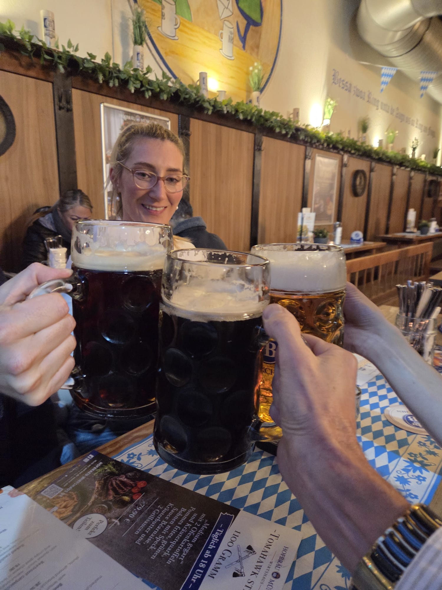Clinking two one-litre steins of beer inside the lively hall