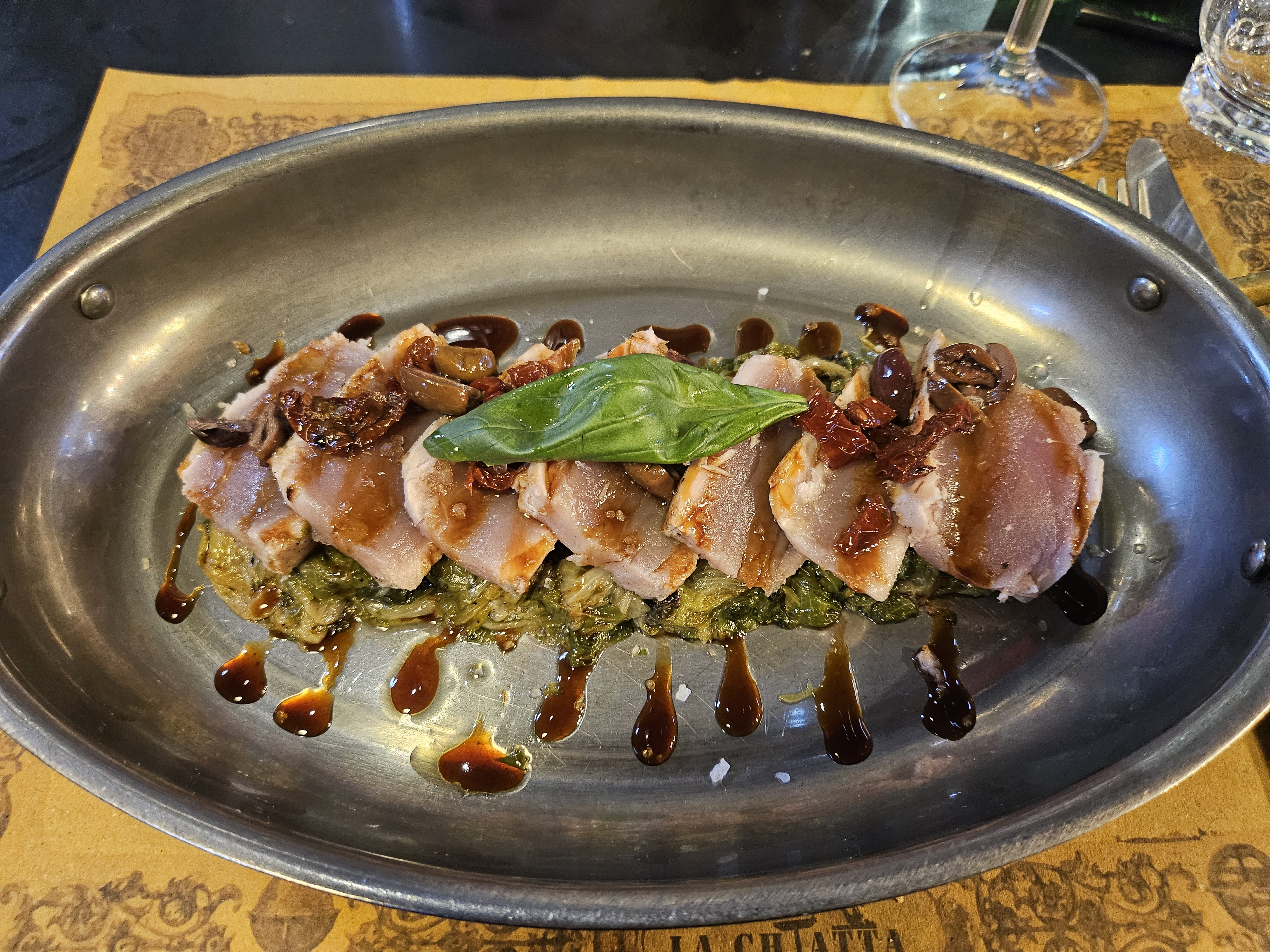 Seared sesame tuna steak served aboard La Chiatta floating restaurant on Navigli canal