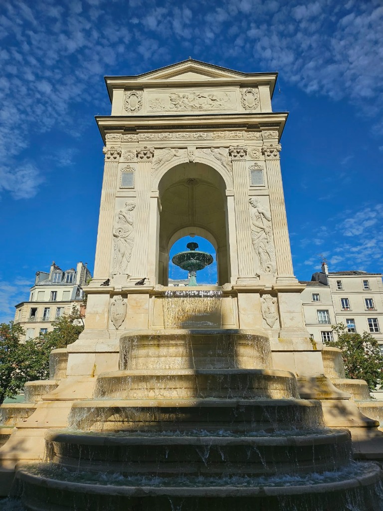 Fontaine des Innocents Renaissance stone fountain under blue sky