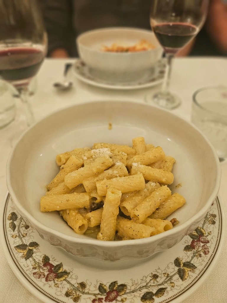 Authentic Roman rigatoni carbonara and red wine at Trattoria Perilli