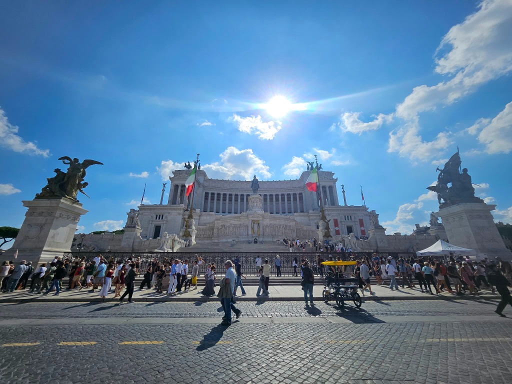 Altare della Patria Vittoriano monument under bright sun with Italian flags